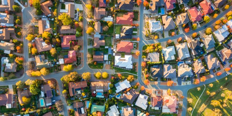 A top-down aerial view of a colorful neighborhood with fall foliage.