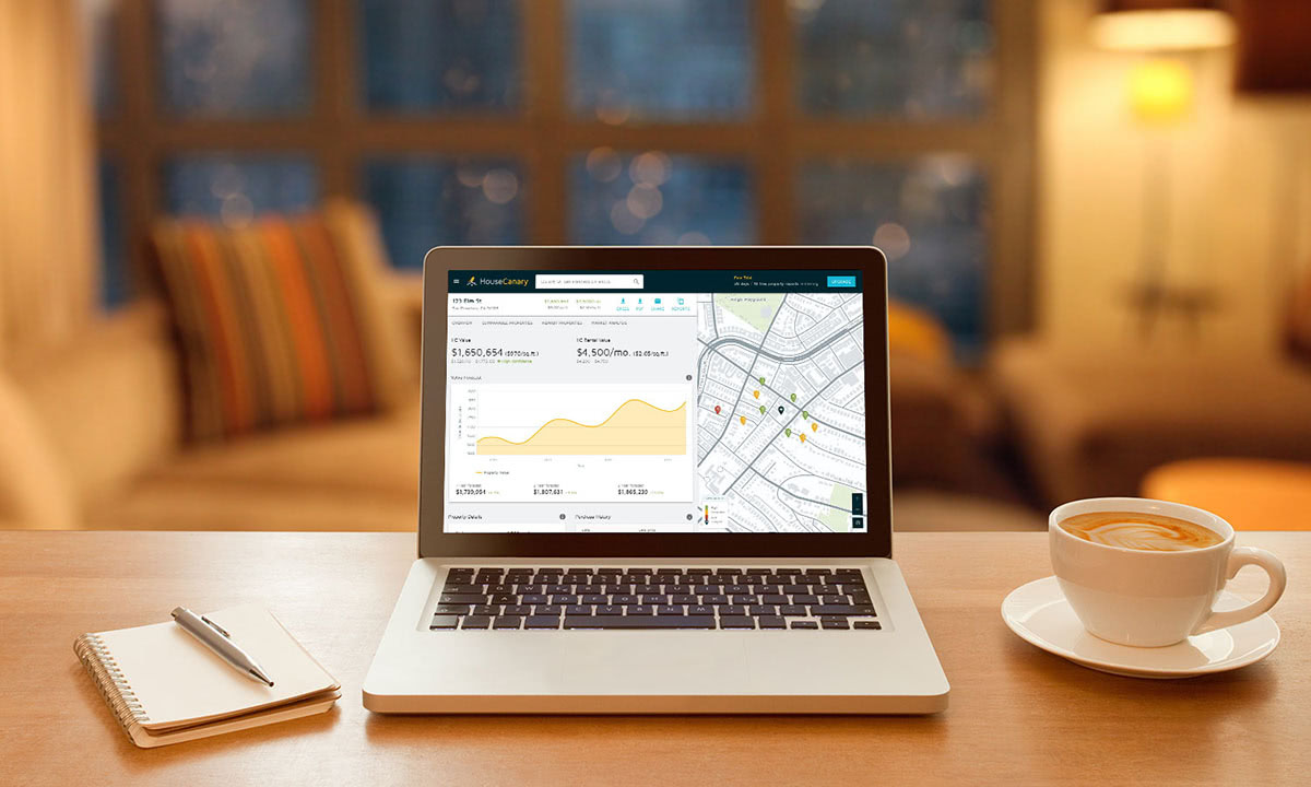 An image of an open laptop in an interior of a house.